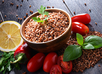 Bowl of buckwheat kasha on wooden table