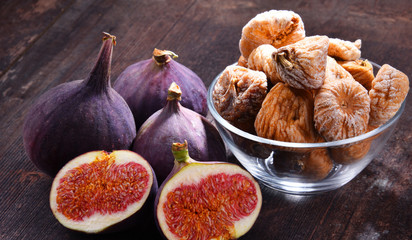 Composition with fresh and dried figs on wooden table