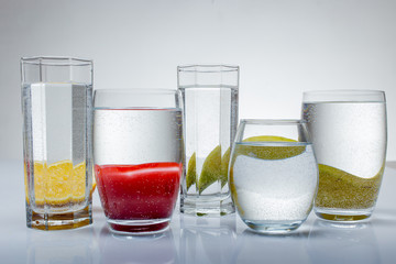 glass of water on white background with fruits