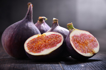 Composition with fresh figs on wooden table