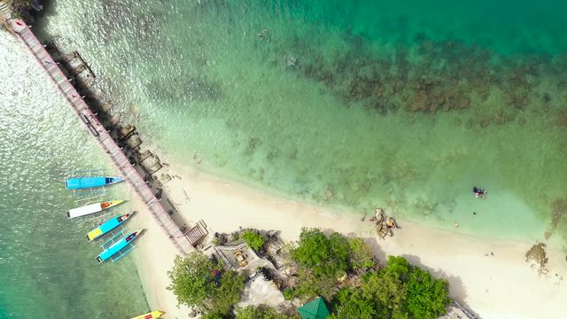 aerial view of the beach. Sandy beach on a tropical island with turquoise water and tourists- view from above. Quezon Island Beach, Hundred Islands National Park, Pangasinan, Philippines. Alaminos.