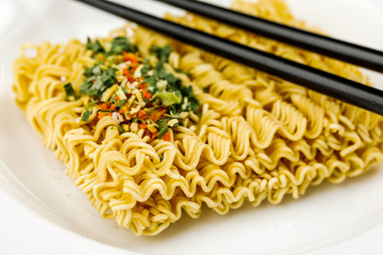 Macro Photography Of Dry Instant Noodle On Plate With Chopsticks