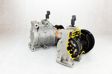 New car compressor with cutted car compressor on white background