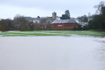 Naklejka na ściany i meble Flooded Axe Valley in East Devon, UK during the storm Dennis. Agricultural fields around river Axe near town of Axminster.