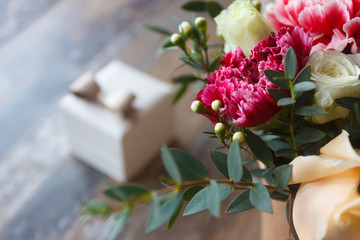 A present box and a bouquet of flowers, blurred background