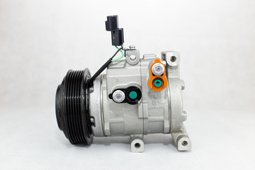 New car air conditioning compressor on white background