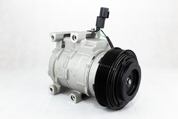New car air conditioning compressor on white background