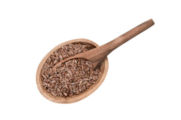 Linseeds or flax seed in a small oval wooden bowl with a spoon seen directly from above and isolated on white background