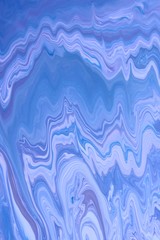Purple-blue marble abstract background. Natural stone texture. Acrylic paint flows freely and...