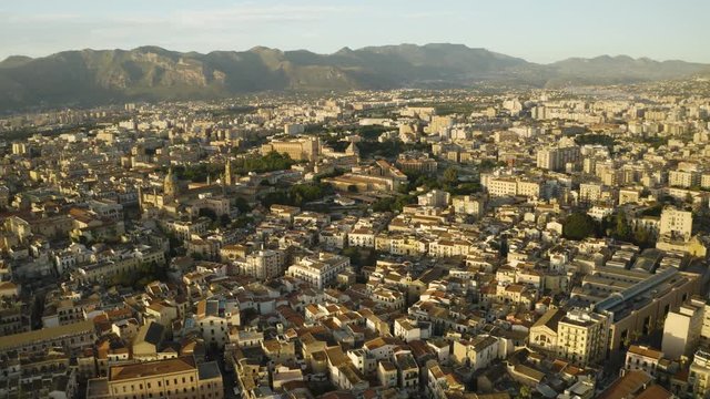 Cinematic flight early sunny morning over the Palazzo dei Normanni, Cappella Palatina, and Cattadrale Santa Vergine Maria Assunta in the historic part of Palermo. Sicily, Italy. May 2019. Aerial shoot