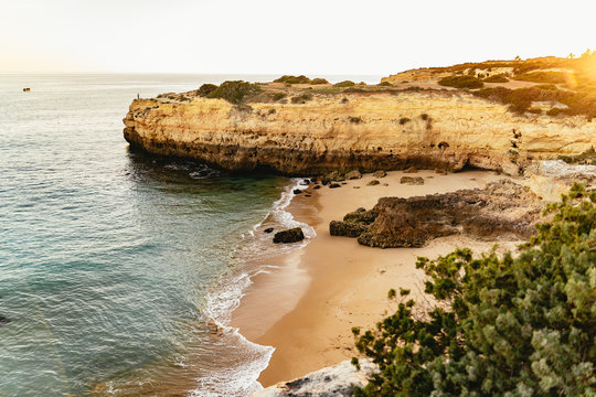 Secluded sandy beach between steep cliffs