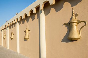 decorative wall in gold color with a bas-relief of Arabic architecture