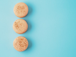 French macarons isolated on blue background.