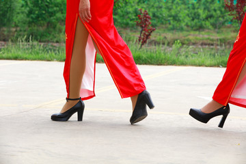 red cheongsam ladies in the park