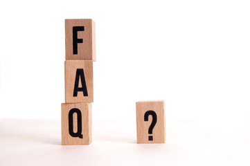 FAQS wooden blocks and Questions Mark ( ? ) word with wooden cube block on bright background. FAQ(...