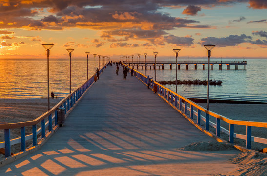 Fototapeta Colorful sunset at a famous marine pier in the Baltic resort city of Palanga, Lithuania, Europe