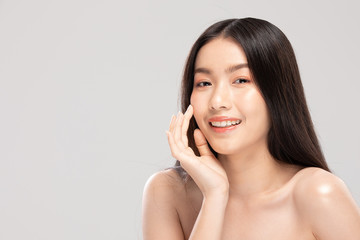 Asian young woman touching soft cheek smile with clean and fresh skin