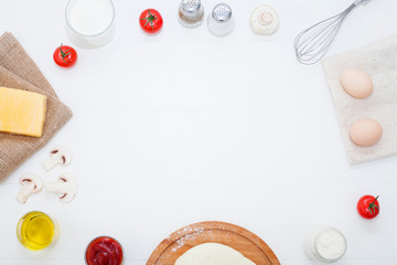 Ingredients for cooking, Cutlery are arranged around the text space, on a white background. The concept of meal recipes, making dough and pastries.