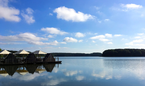 panoramic view of the landscape of lake Oberpfuhl in Lychen/Germany on a summer morning with clouds reflecting in the water