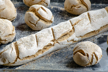 freshly baked bread on the dark table