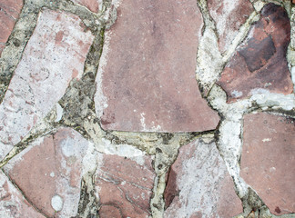 Naklejka premium Coarse structure of pink debris with gray cement.