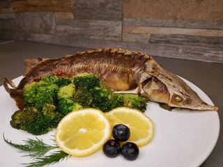 fish with lemon and herbs on a plate