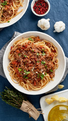 Pasta Bolognese Fettuccine with mincemeat and tomatoes, parmesan cheese. Top view, vertical