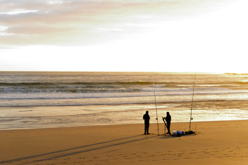  Fishermen on the beach at sunset