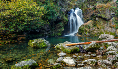 Wonderful Autumn landscape with Beautiful little waterfall in forest. Waterfall at Soteska vintgar,...