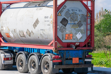 Naklejka premium Container approved for the transport of dangerous goods, with orange panels with numbers indicative of the adjacent danger and toxic cargo label.
