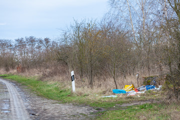 garbage illegally disposed of on the edge of the road