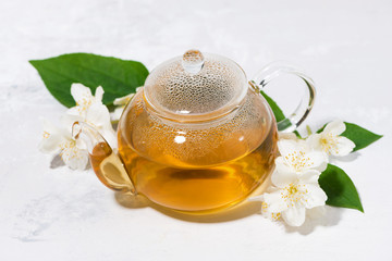 Obraz na płótnie Canvas fresh flavored green tea in a glass teapot, top view