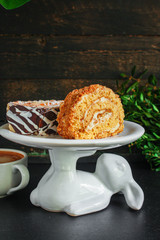 piece of cake on a stand tortoise maker biscuit roll (delicious sweet honey dessert) menu concept. background. top view. copy space