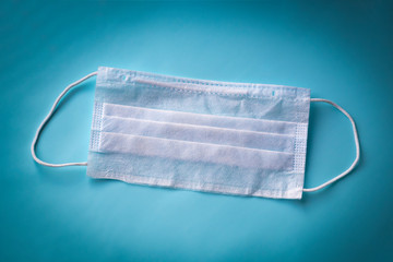 medical mask for protection against bacteria. On a blue background. Close-up