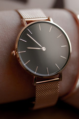 Stylish elegant golden watch on woman hand