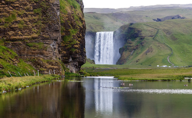 Gorgeous nature of Iceland. Impressively View on Skogafoss Waterfall with reflection in sunny day. Skogafoss the most famous place of Iceland. Unique place on earth. Popular Travel Location