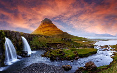 Majestic Kirkjufell volcano the coast of Snaefellsnes peninsula. Picturesque and gorgeous scene. Kirkjufellsfoss, Iceland, sightseeing Europe. Amazing picture of the popular tourist attraction.
