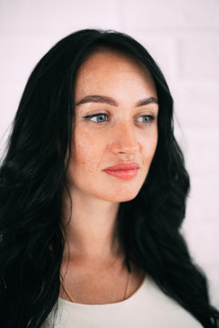 Portrait of brunette girl without retouching, visible skin problems