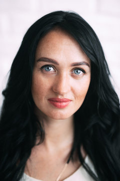 Portrait of brunette girl without retouching, visible skin problems