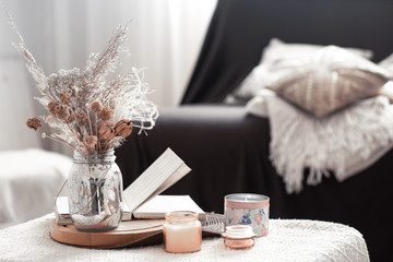 Home cozy still life with a black sofa and decor in the living room.