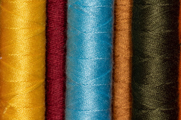 Cones with bright colored sewing thread 