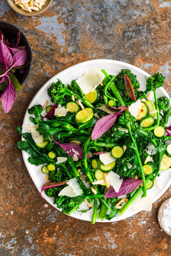 Broccoli salad with fresh leaves, basil, zucchini, almonds and Parmesan cheese