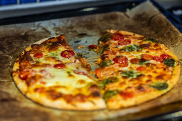 Newly baked pizza with tomato, mozzarella, onion, broccoli and cheese