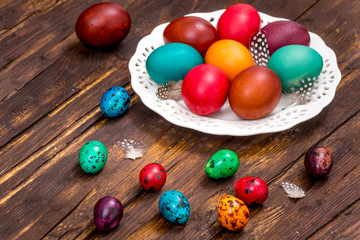 Traditionally painted quail eggs on a wooden background.  Happy Easter  