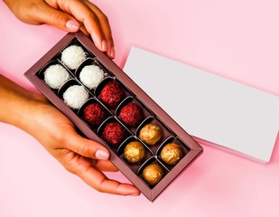 Chocolate box in hands.
