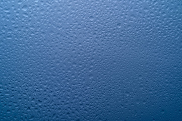  water drops on glass on a blue background