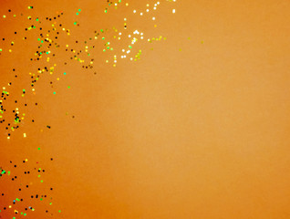 Brown yellow golden confetti background.