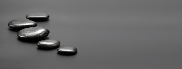 Black stones on gray. Nature horizontal background.