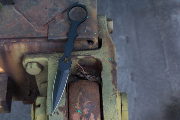 All-metal knife on the towbar of the machine. War machine and knife.