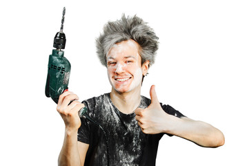 Dirty young builder guy in plaster is hold a green drill perforator on isolated background at home...